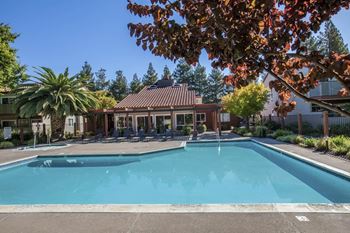 a swimming pool in front of a house with a pool at Valley Plaza Villages, Pleasanton